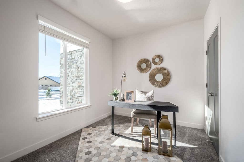 an office with a large window and a table with two bottles