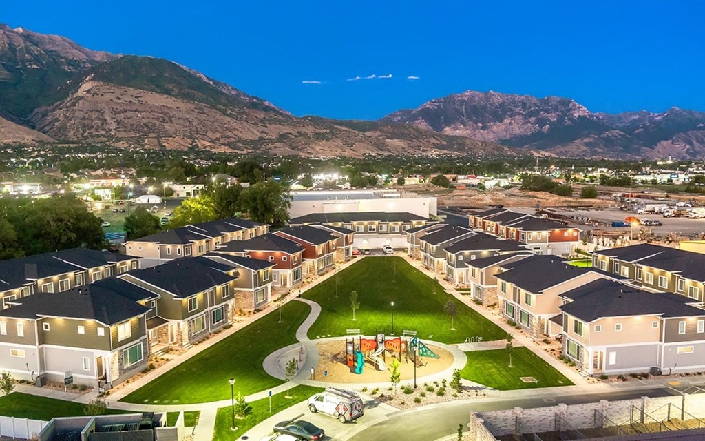 an aerial view of a park with houses and a playground