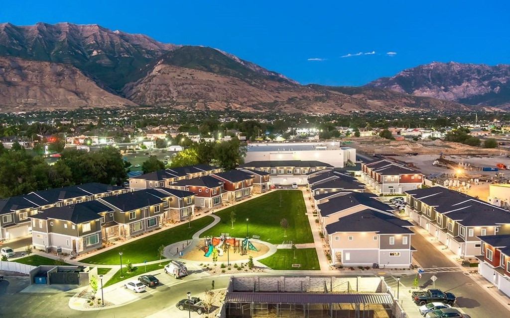 an aerial view of a city with mountains in the background