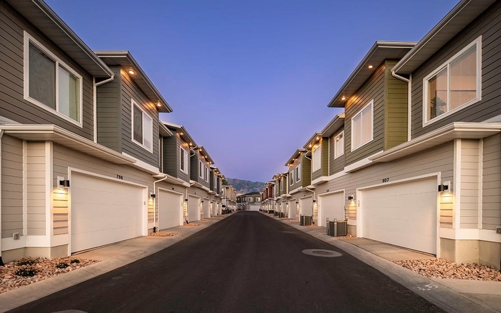 a street lined with houses with white garage doors