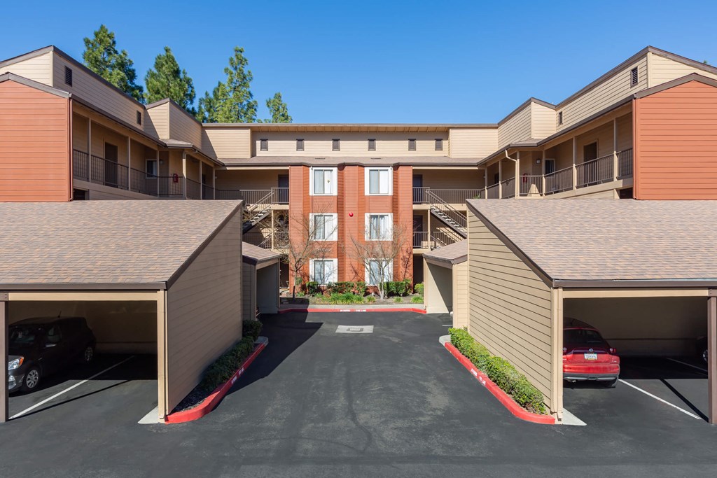 an empty parking lot in front of an apartment building