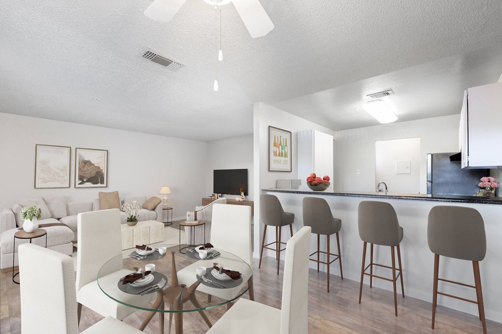 a living room and dining room with a glass table and chairs