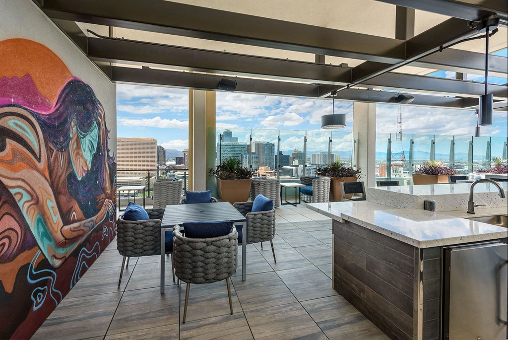 a dining room with a view of a city and a table and chairs