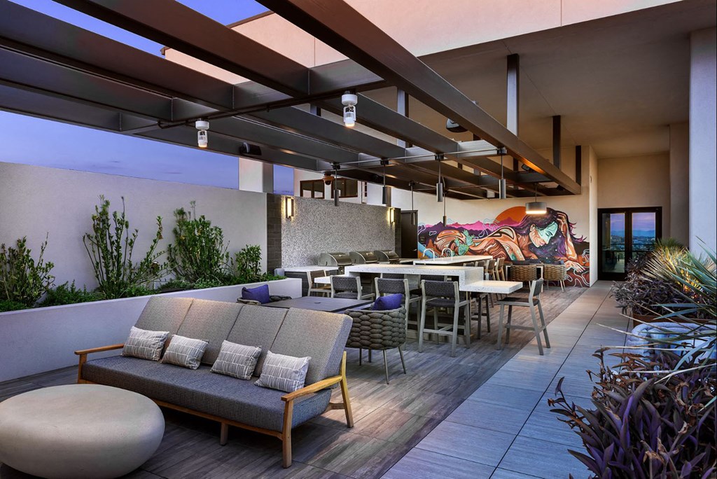 a rendering of a patio with tables and chairs and a mural