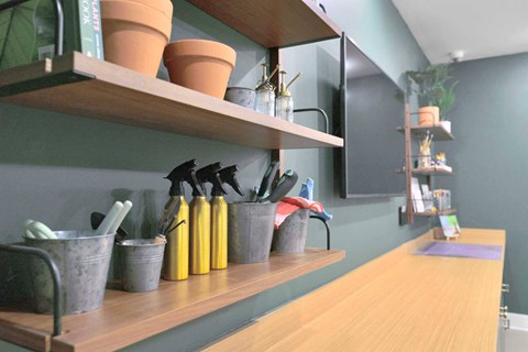 a kitchen counter with pots and utensils on a shelf