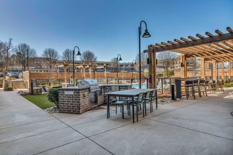 a patio with tables and chairs and a building in the background