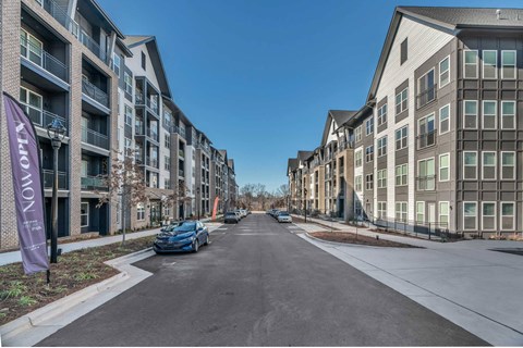 an empty street with a large apartment building on the side of it