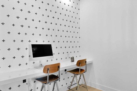 a room with two chairs and a desk with a monitor