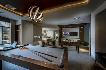 a game room with a pool table and a tv