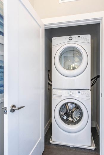 a white washer and dryer in a small laundry room