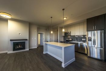 a kitchen and living room with a fireplace