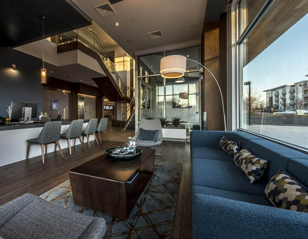 a large living room with a blue couch and a coffee table