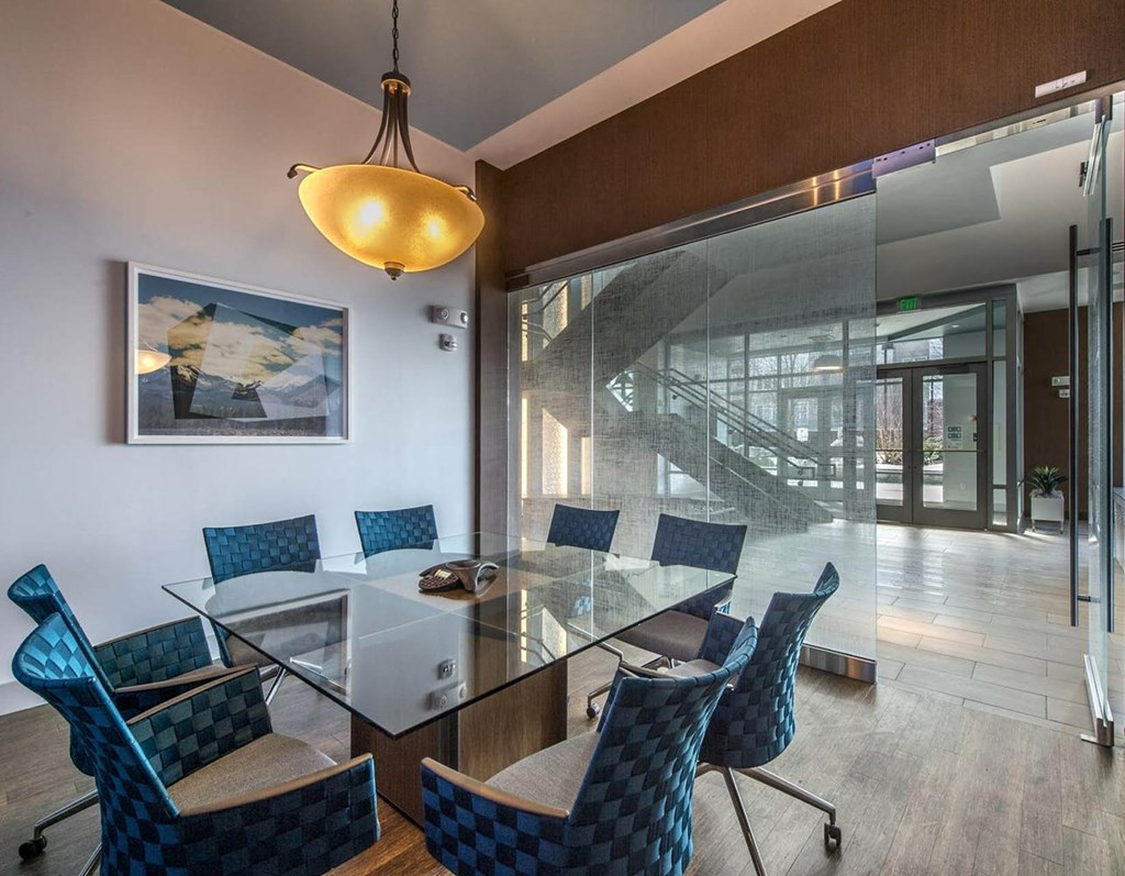 a conference room with a glass table and chairs