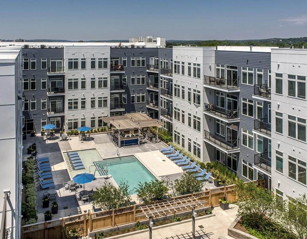 an aerial view of an apartment building with a swimming pool