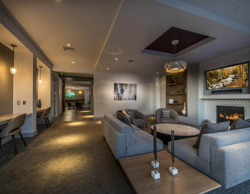 a living room with couches and a table and a fireplace