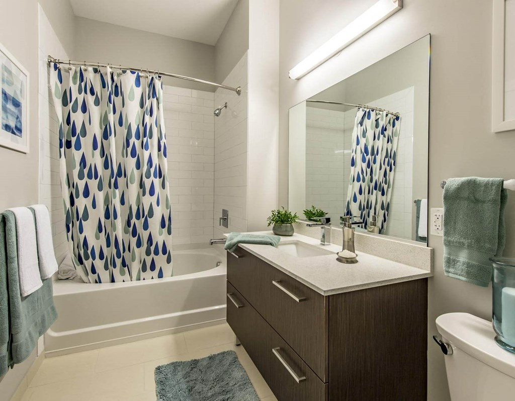 a bathroom with a shower and a sink and a mirror