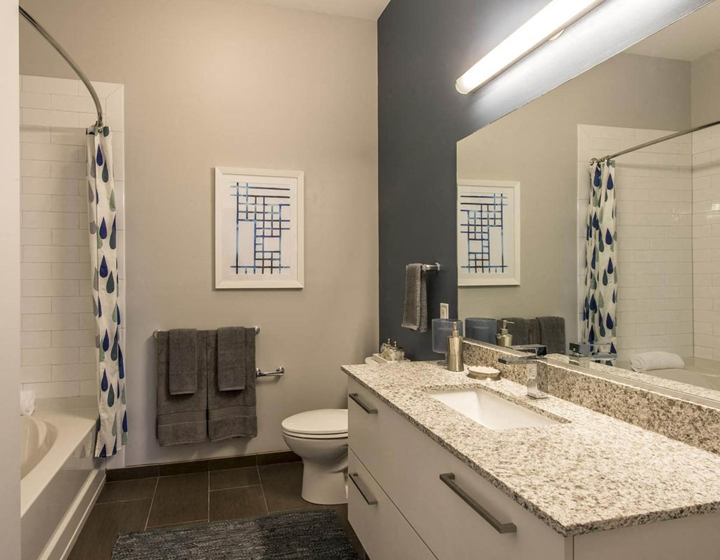 a bathroom with a sink toilet and a mirror
