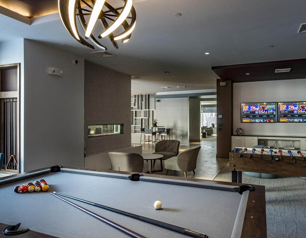 a game room with a pool table and a television