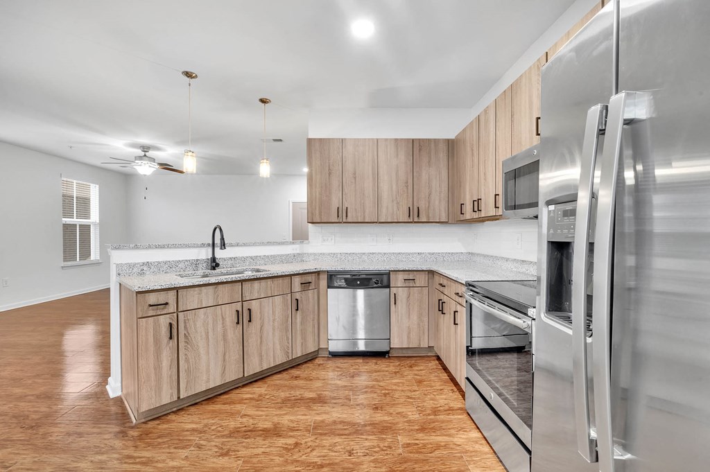 a kitchen with wooden cabinets and stainless steel appliances