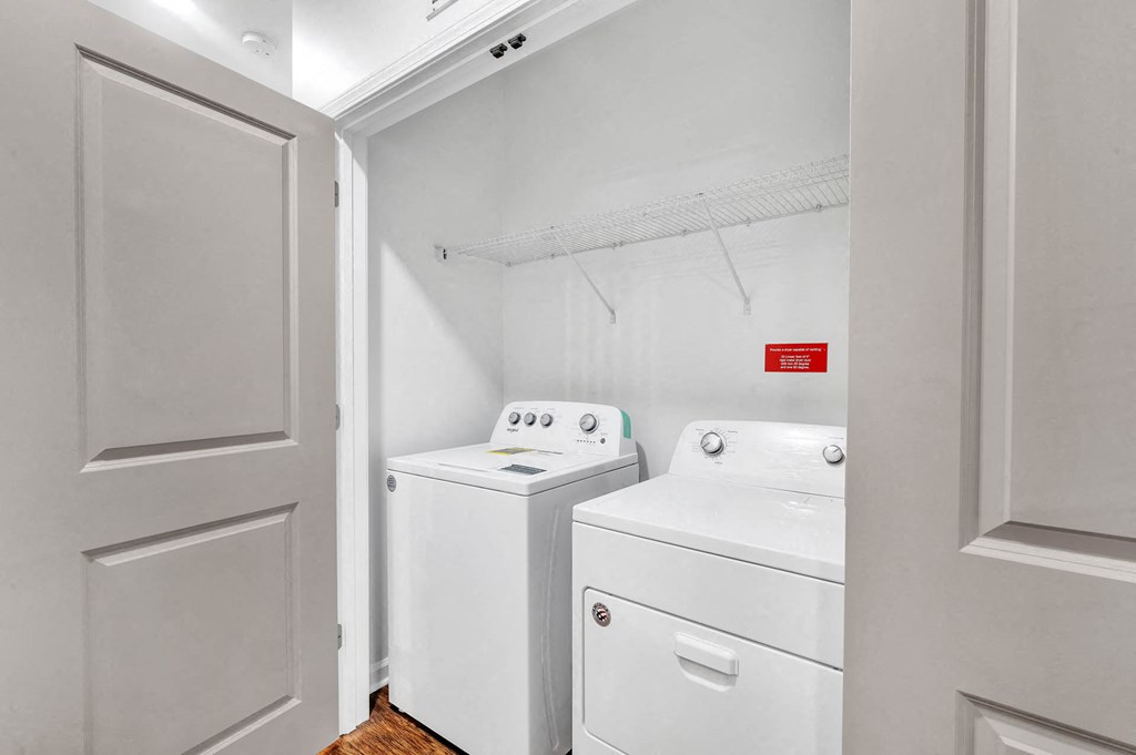 a white laundry room with a washer and dryer