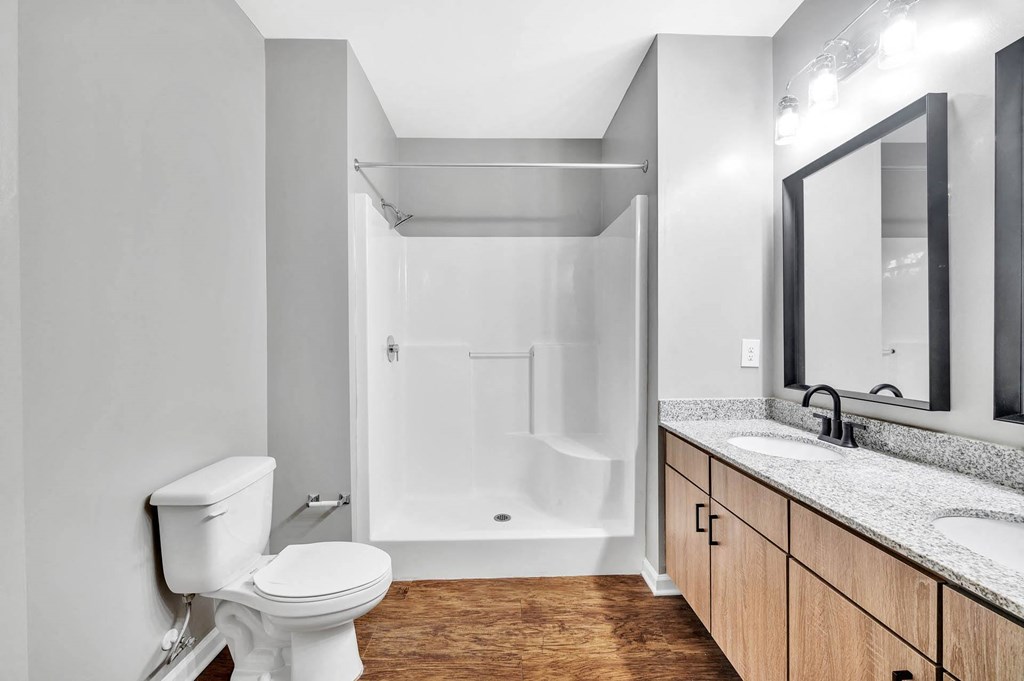 a bathroom with a toilet and a sink and a shower