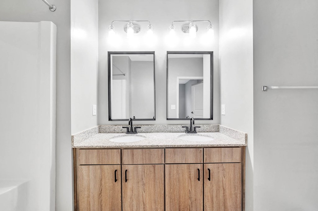 a bathroom with two mirrors and two sinks
