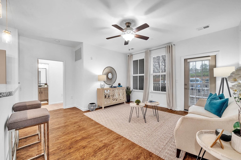 a living room with a couch and a ceiling fan