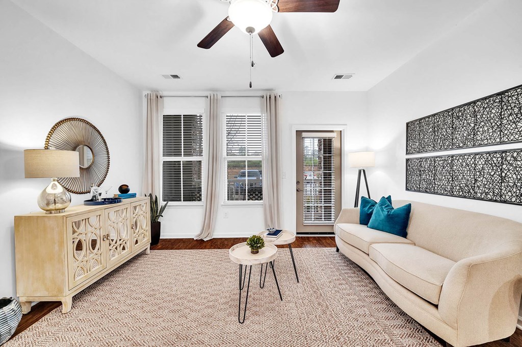 a living room with a couch and a ceiling fan