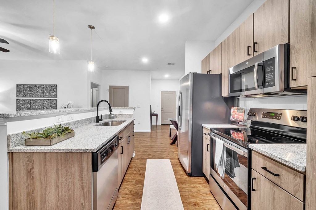a kitchen with stainless steel appliances and marble counter tops