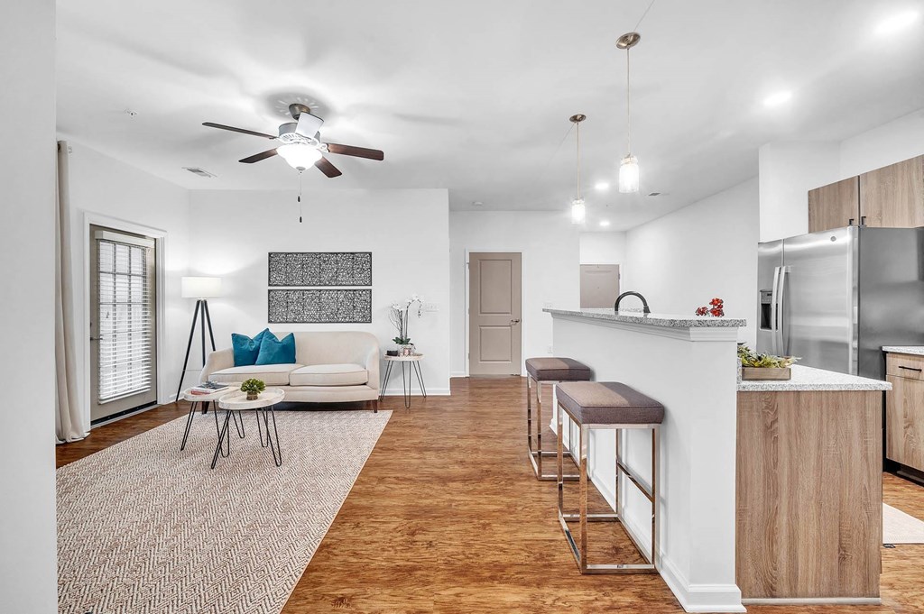 a kitchen and dining room with a wood floor and white walls