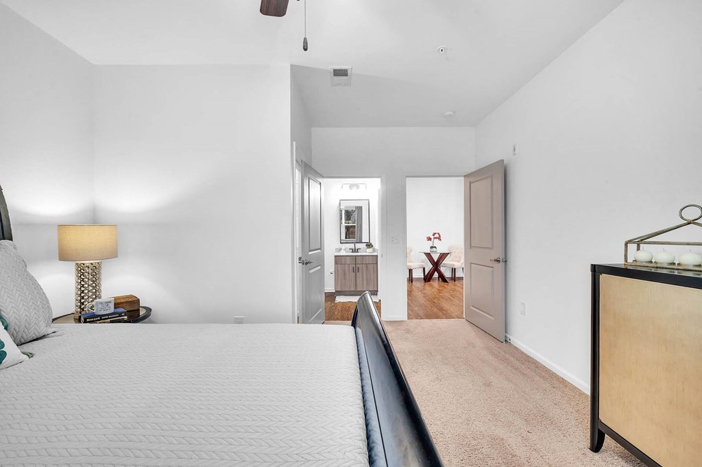 a bedroom with a large bed and a door to a bathroom