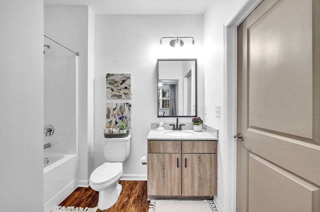 a bathroom with a toilet sink and a mirror