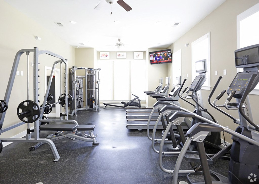a row of exercise equipment in a gym