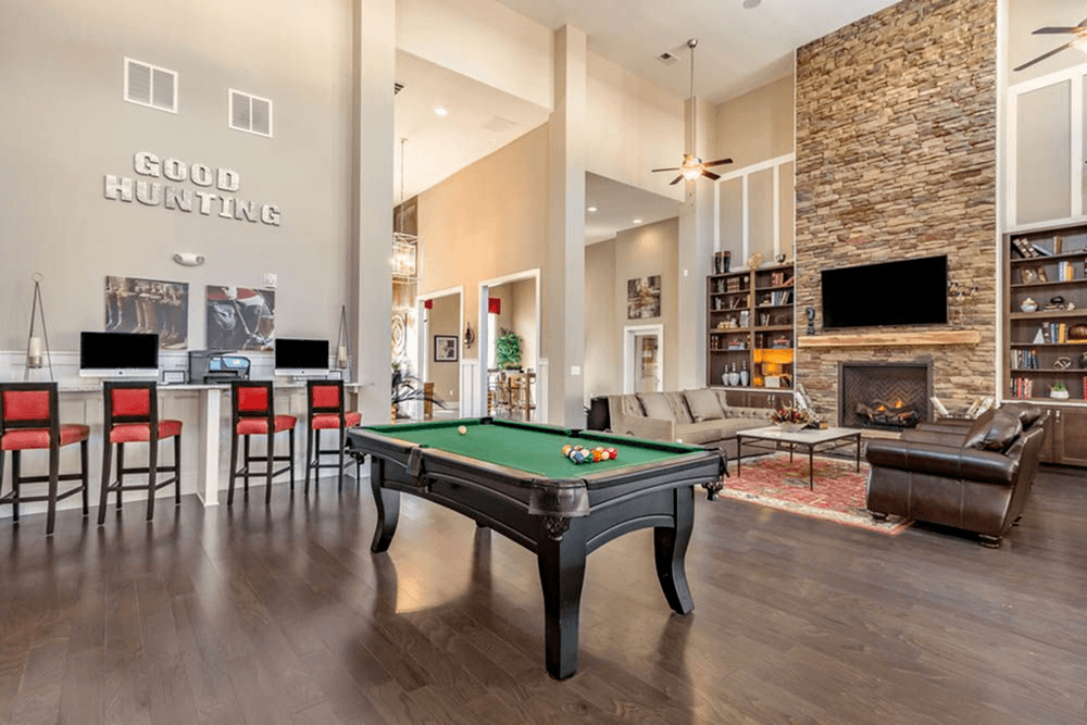 a pool table in a living room with a fireplace