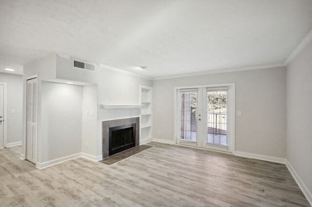 an empty living room with a fireplace and a window
