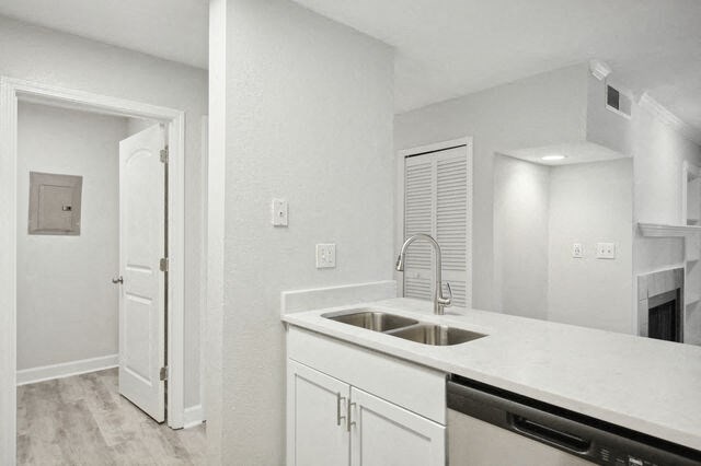 a white kitchen with a sink and a refrigerator