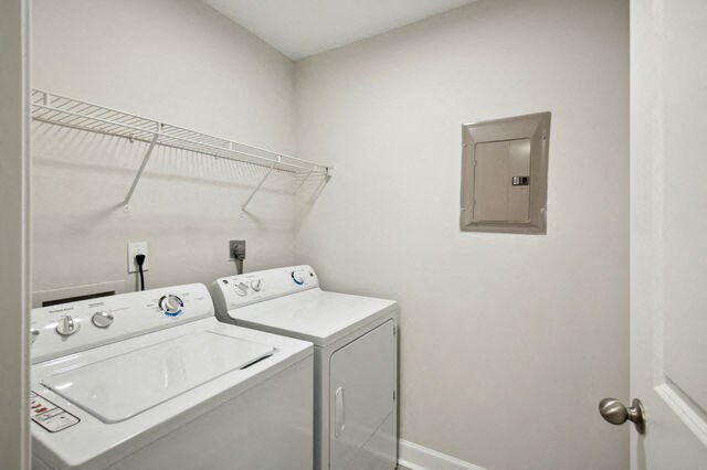 a white laundry room with a sink and a washer and dryer