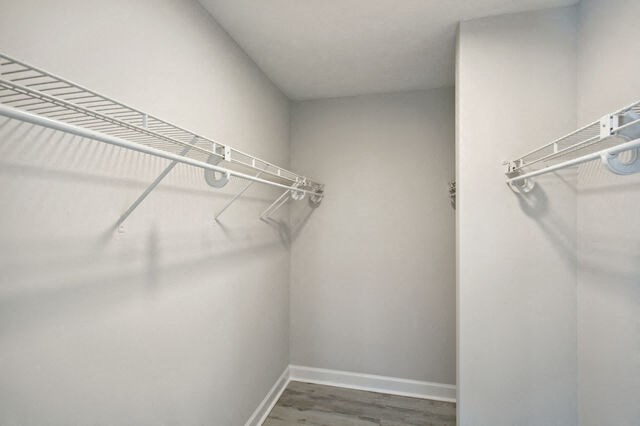 an empty closet with two hanging rails in a white room