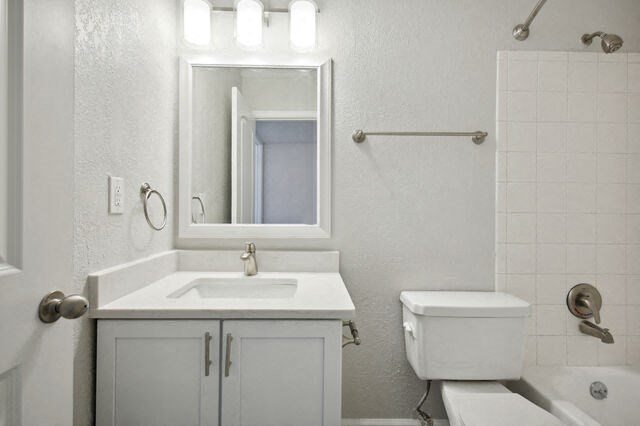 a white bathroom with a sink toilet and a mirror