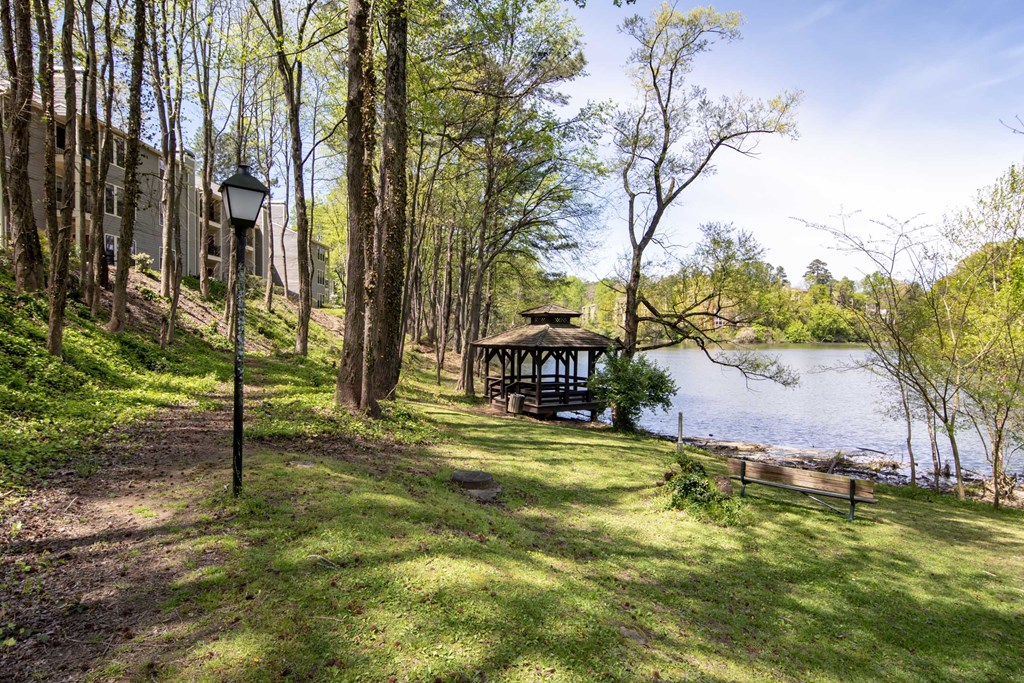a gazebo on the shore of a lake