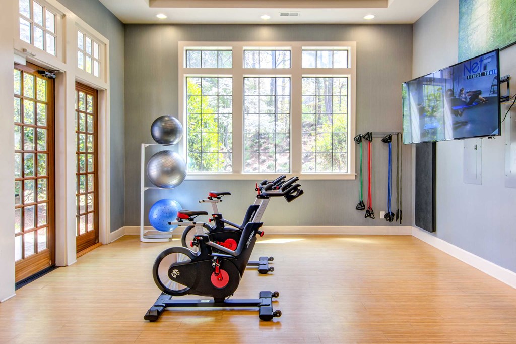 the home gym has plenty of windows and space for exercise equipment