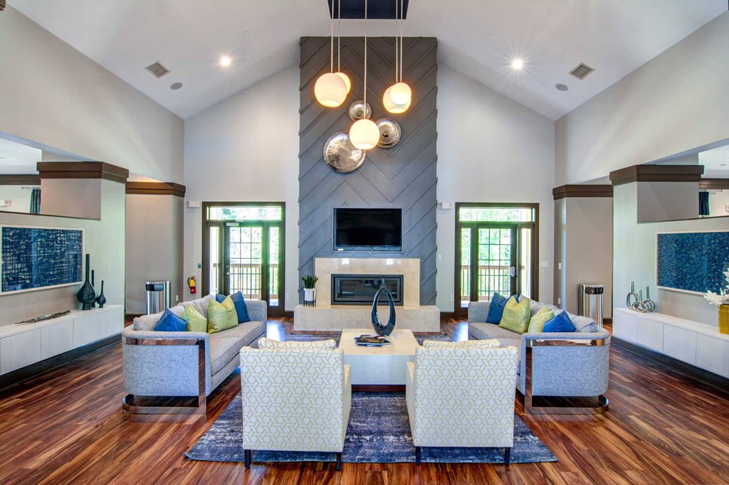 a living room with couches and chairs and a fireplace