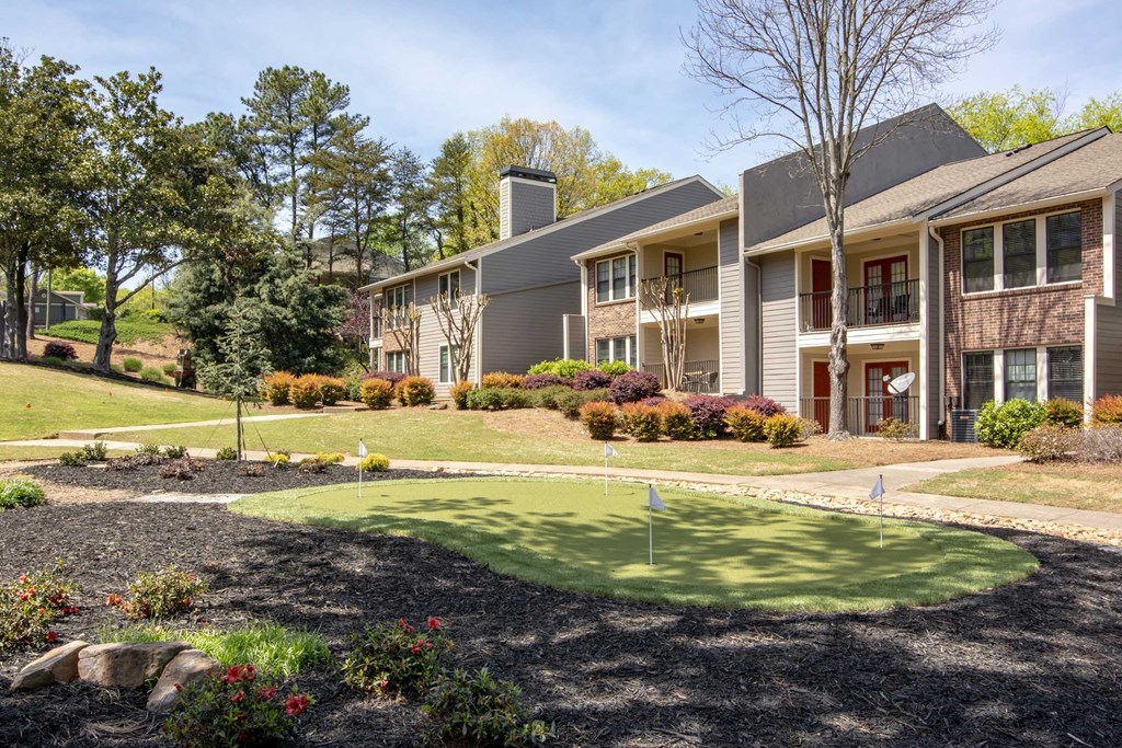 a putting green in front of an apartment building