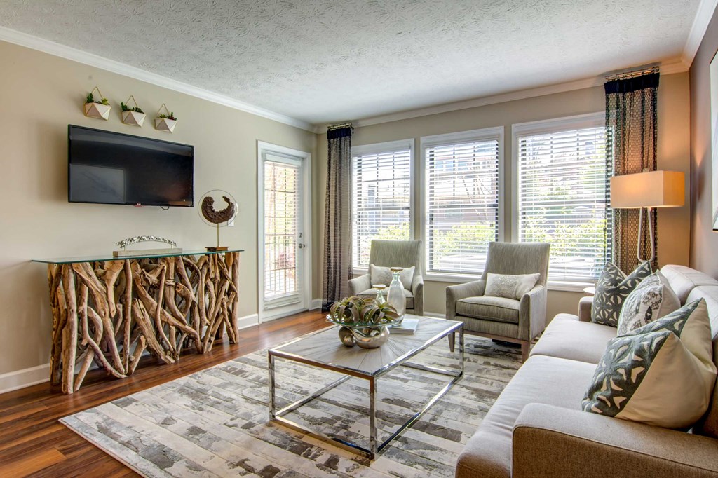 a living room with a couch and chairs and a television