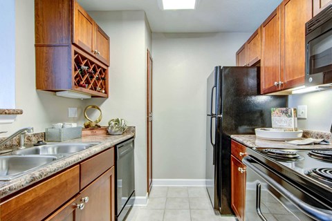 a kitchen with stainless steel appliances and wooden cabinets