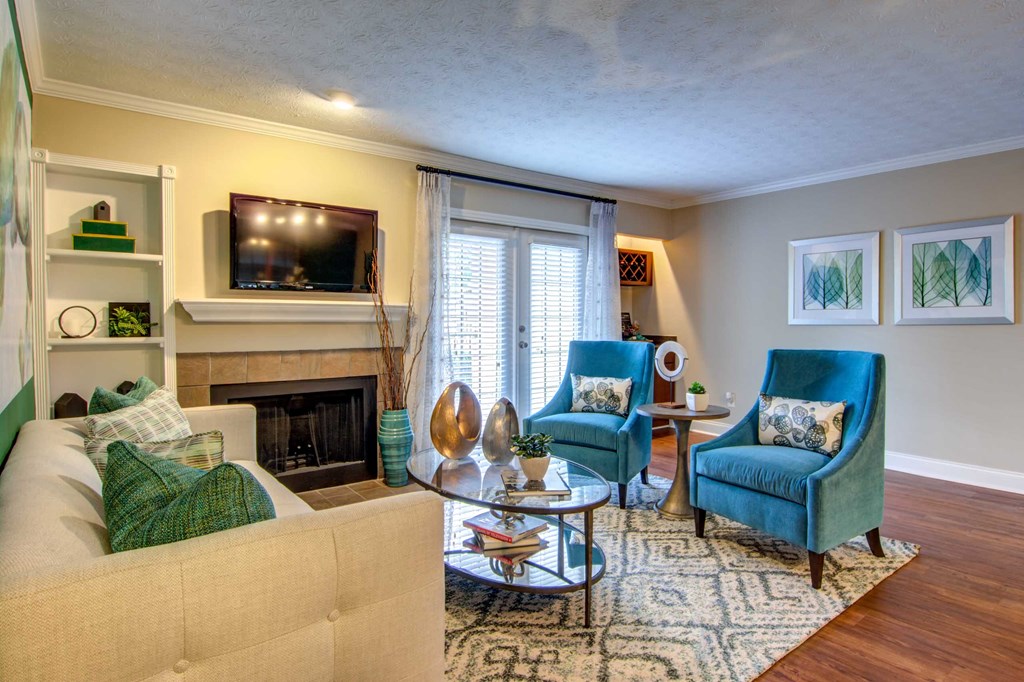 a living room with a couch and chairs and a fireplace