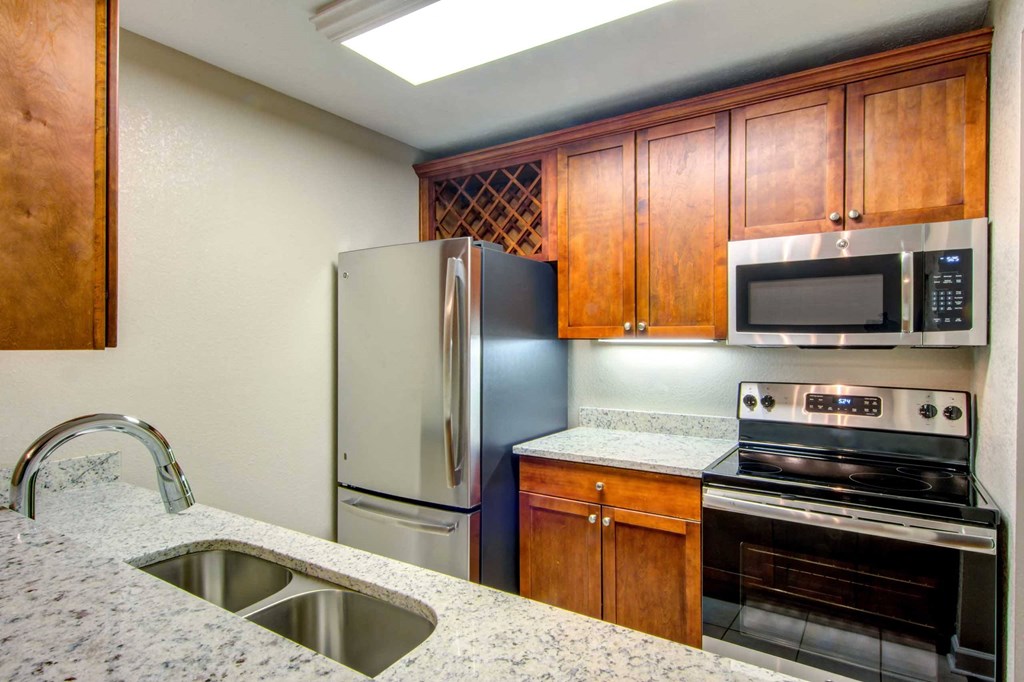 a kitchen with stainless steel appliances and granite counter tops