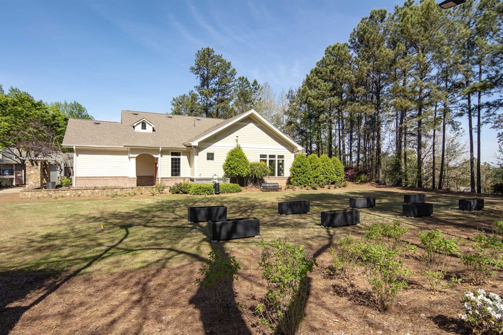 a house with a yard and chairs in front of it