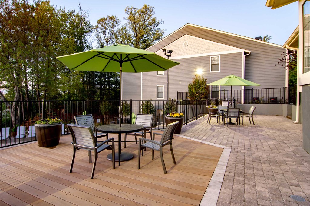 a patio with tables and chairs and umbrellas