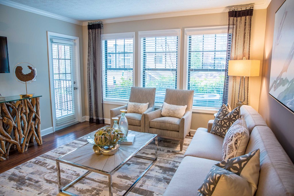 a living room with a couch and chairs and a table